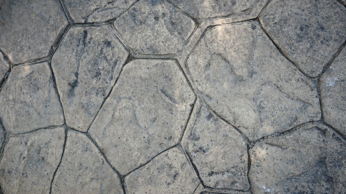 Close-up of gray stamped concrete in a fieldstone pattern